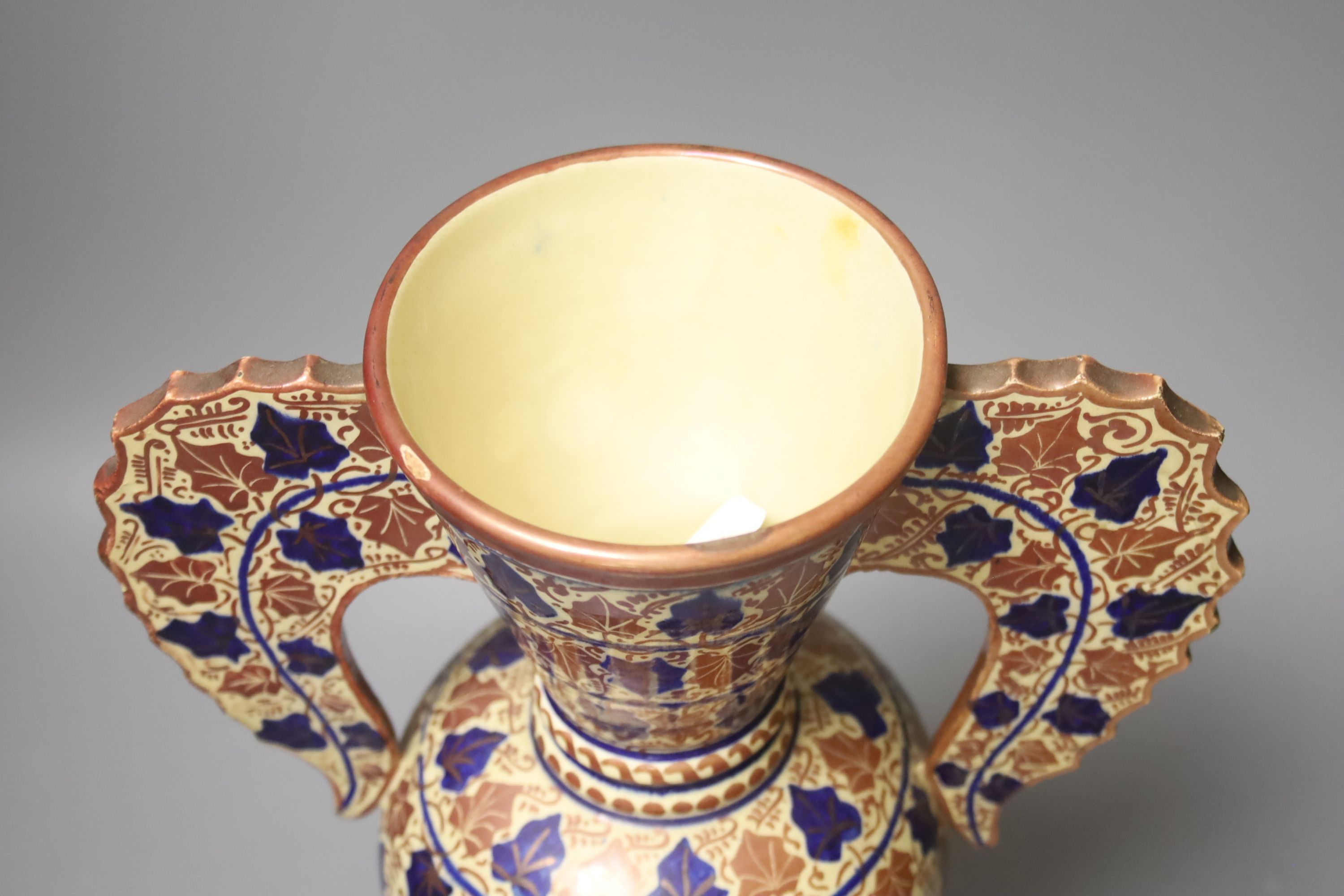 A Persian copper lustre two handled vase